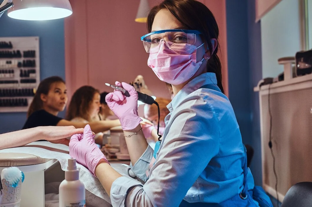 attractive-cheerful-manicurist-is-posing-photographer-while-doing-maicure-customer_613910-20773